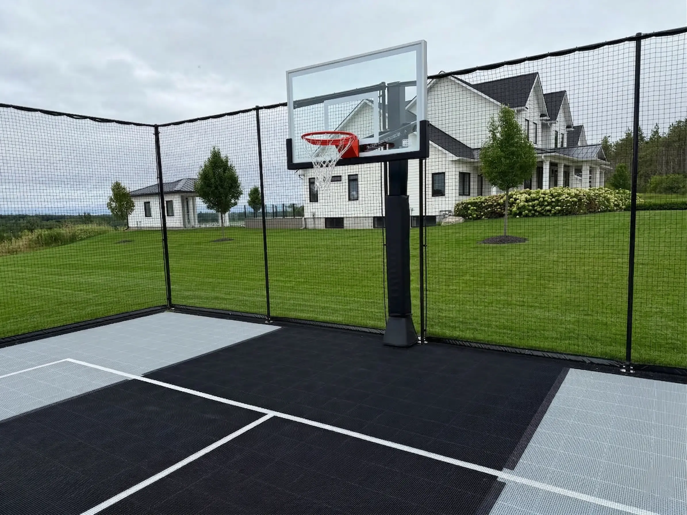 Backyard sports court with integrated hardscape