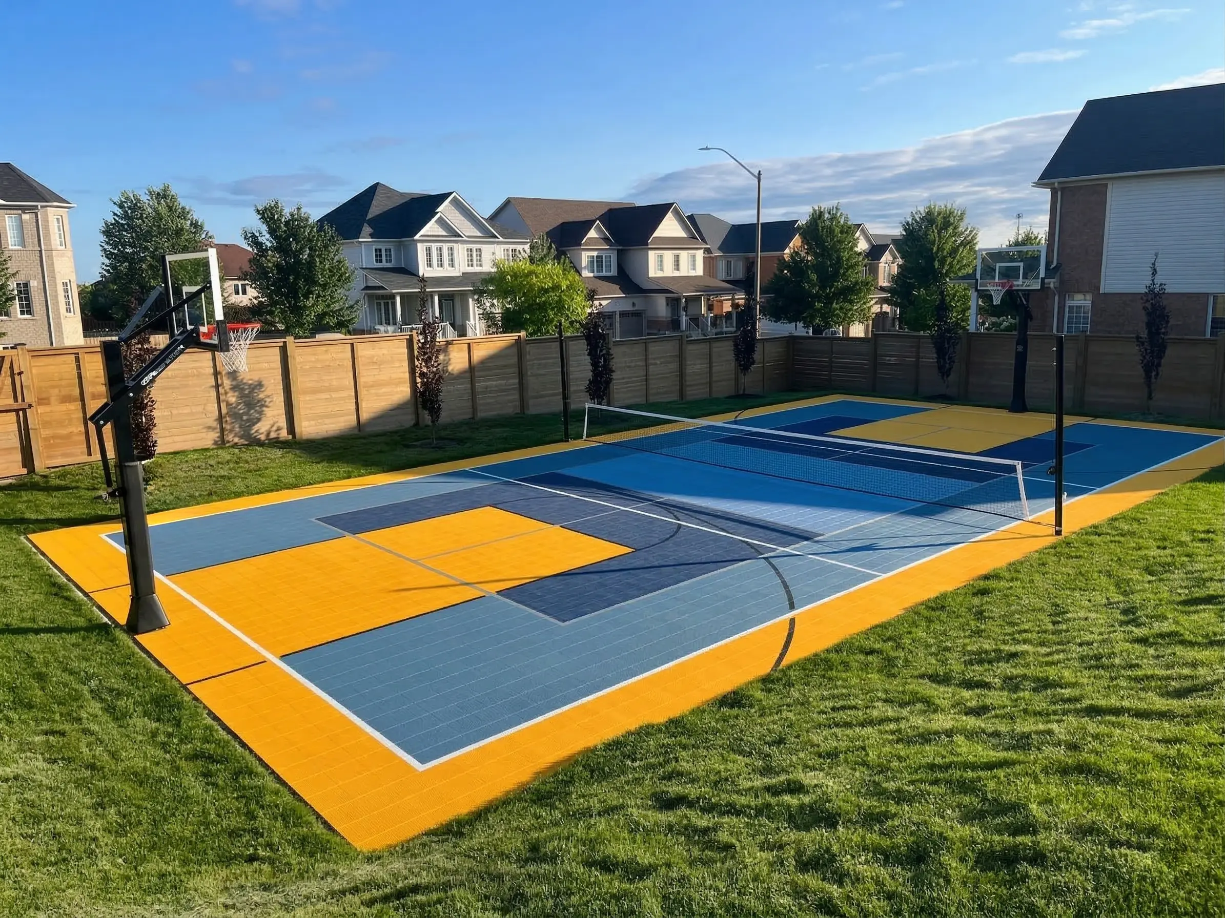 Colorful multi-sport court and open backyard with patio and lawn.